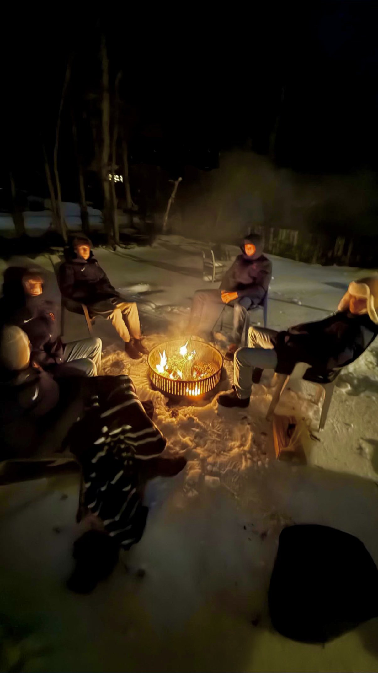 Friends around a campfire in the snow